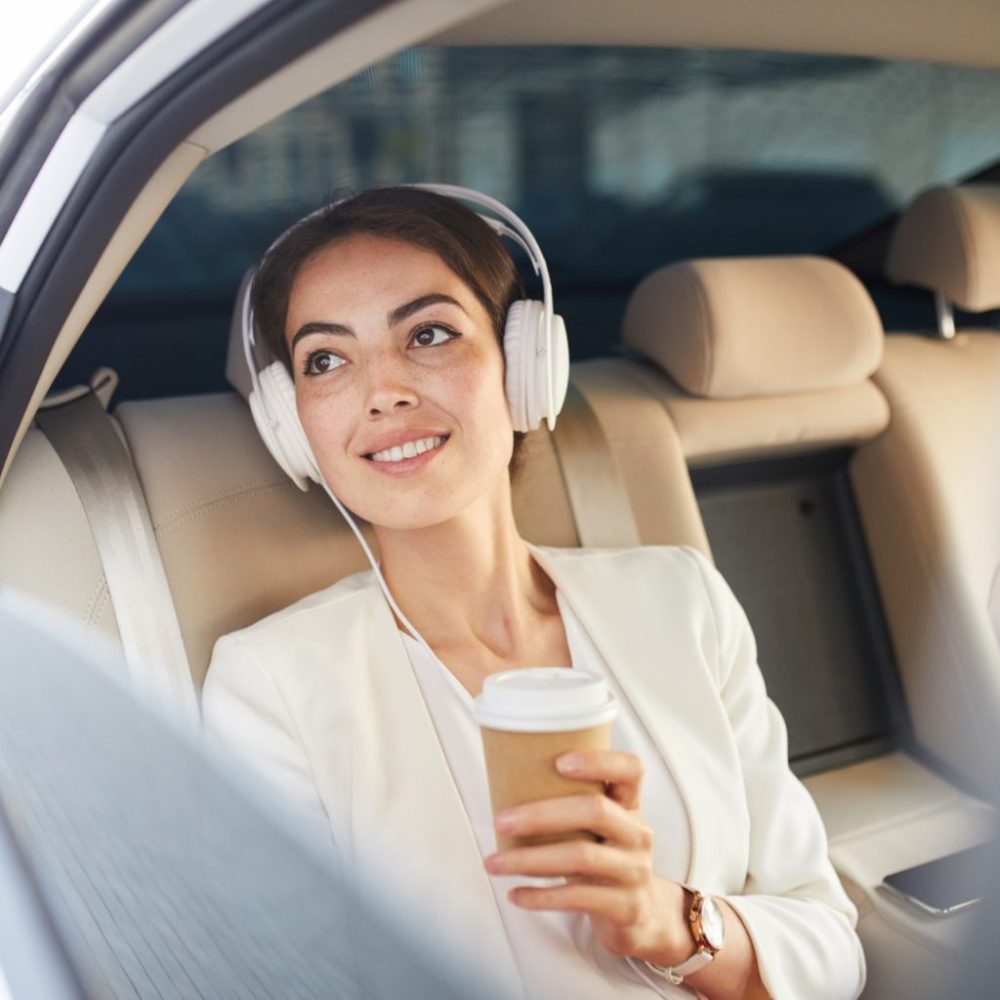 businesswoman-listening-to-music-in-taxi-e1688700565478-1536x1024